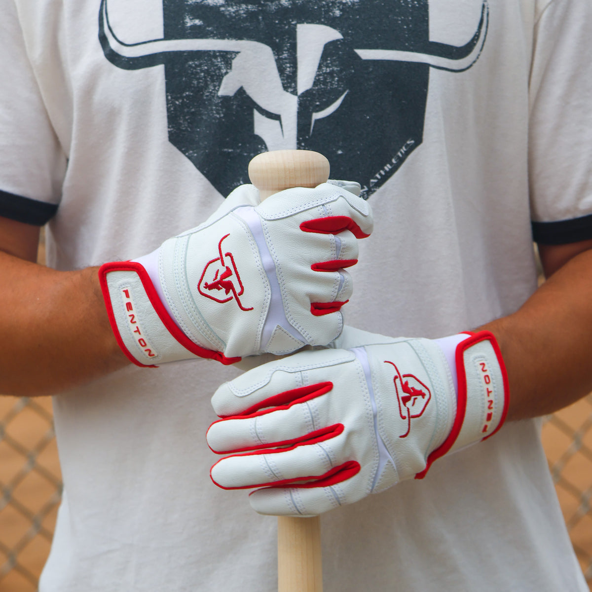 Baseball player holding a bat wearing Incognito batting gloves